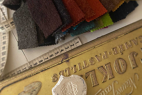 Color swatches with a measuring tape on top of a vintage box.