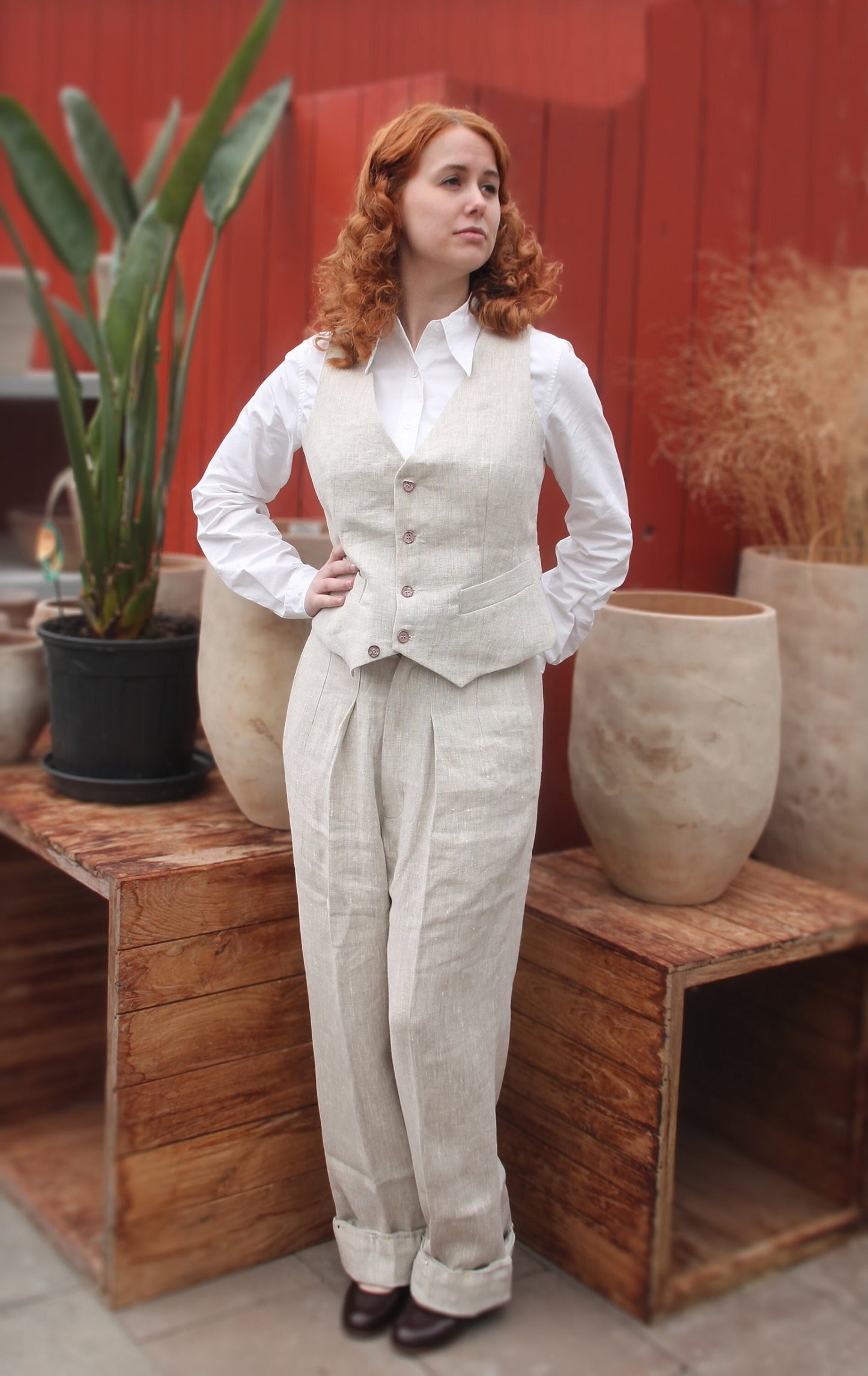 1930s style ladies suit pants for women in natural colored linen. These trousers are adapted from a 1930s mens pattern with wide fit, pleated front, very high waisted, fishtail back and buckle back. The trousers are worn with a matching waistcoat